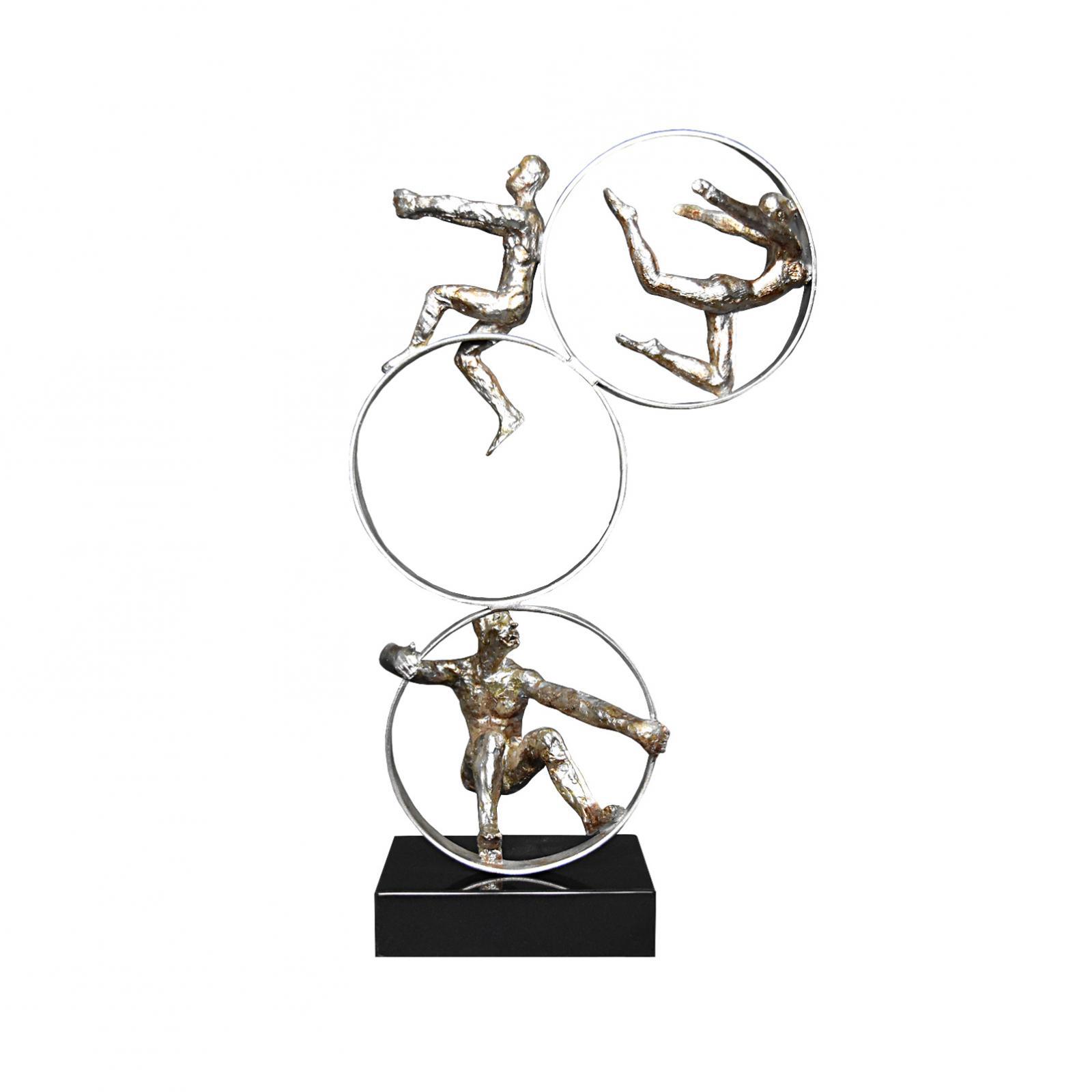 three acrobats gold sculpture